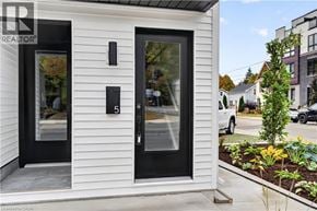 Dundas apartment for rent - A white house with a black door and window.