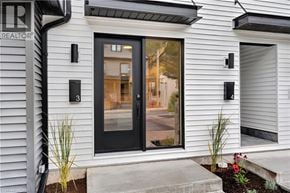 Dundas apartment for rent - A modern house with a black door and windows.