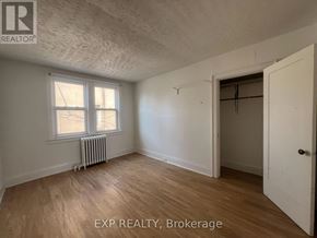 Toronto (Wychwood) multi-family for rent - A room with EXP REALTY, Brokerage written on the wall.