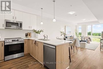 London North (North B) apartment for rent - A modern kitchen with wooden cabinets and stainless steel appliances.