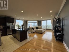 London East (East F) condo for rent - A modern kitchen with a bar area and a view of the city.