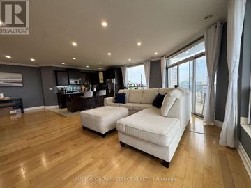 London East (East F) condo for rent - A living room with a white sofa and wooden flooring.