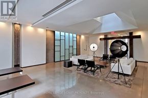 Toronto (Niagara) condo for rent - A spacious living room with a black and white color scheme.