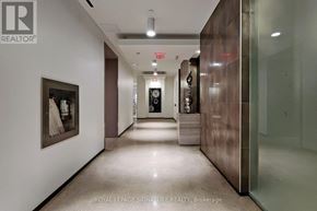 Toronto (Niagara) condo for rent - A hallway with a glass door and a painting on the wall.