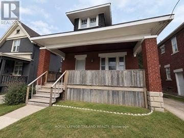 London East (East L) apartment for rent - A house with a porch and a white picket fence.