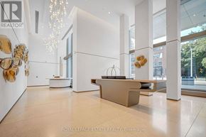 Toronto (Annex) condo for rent - A reception area with a white reception desk and golden decorations.