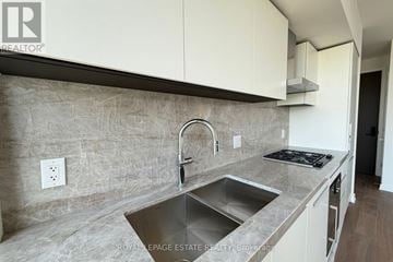 Toronto (Annex) condo for rent - A kitchen with a sink and a stove top.