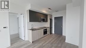 Toronto (Newtonbrook West) condo for rent - A modern kitchen with a wooden floor and white walls.