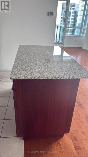 Toronto (Waterfront Communities) condo for rent - A room with a large window overlooking a cityscape.