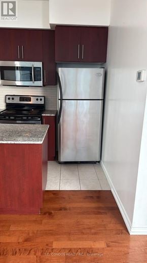 Toronto (Waterfront Communities) condo for rent - A room with a sliding glass door and wood flooring.