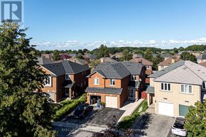 Mississauga (Hurontario) apartment for rent - A residential area with houses and cars parked in front.