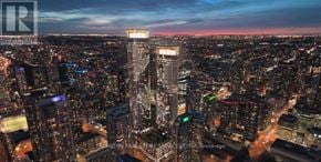 Toronto (Waterfront Communities) condo for rent - A cityscape at dusk with a prominent skyscraper in the center.