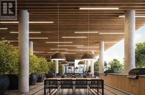 Toronto (Waterfront Communities) condo for rent - A modern outdoor seating area with a wooden ceiling and pillars.