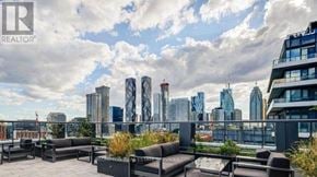 Toronto (Waterfront Communities) condo for rent - A rooftop patio with a view of a city skyline.