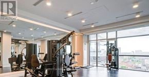 Toronto (Waterfront Communities) condo for rent - A gym with a row of treadmills and a row of stationary bikes.