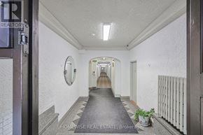 Toronto (Church-Yonge Corridor) condo for rent - A hallway with a sign that says "HOMEWISSE REAL ESTATE Brokerage".