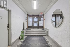 Toronto (Church-Yonge Corridor) condo for rent - A hallway with a door and a mirror on the wall.