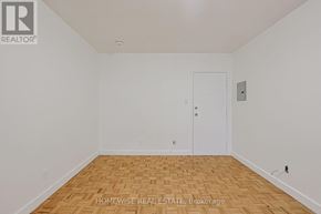 Toronto (Church-Yonge Corridor) condo for rent - A room with a wooden floor and a white door.