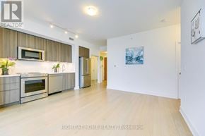 Toronto (Mimico) condo for rent - A modern kitchen with stainless steel appliances and wooden flooring.