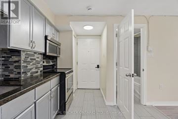 Halton Hills (Ac Acton) multi-family for rent - A kitchen with a black counter top and white cabinets.