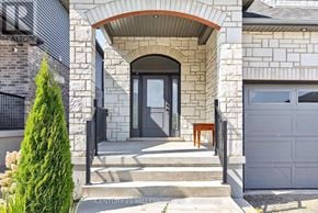 East Luther Grand Valley (Grand Valley) apartment for rent - A house with a stone facade and a black gate.