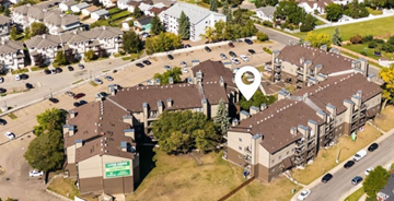 Edmonton apartment for rent - A bird's eye view of a parking lot with a building and a sign that says "Last Stop".