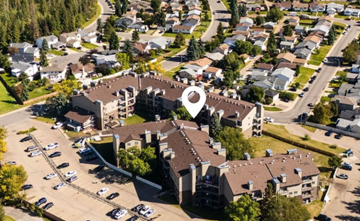 Edmonton apartment for rent - A bird's eye view of a residential area with a parking lot in the foreground.