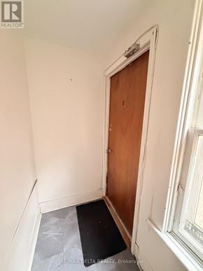 Ottawa multi-family for rent - A room with a wooden door and a black mat on the floor.