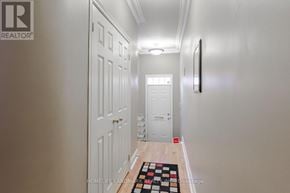 Toronto (Mimico) townhouse for rent - A hallway with a rug on the floor and a door on the left.