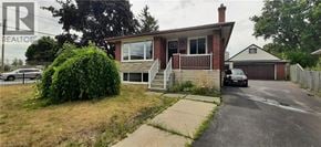 Kitchener apartment for rent - A house with a car parked in the driveway.