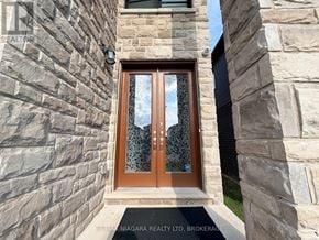 Welland (Lincoln/Crowland) apartment for rent - A brown door with a glass window is set in a stone wall.