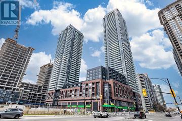 Mississauga (City Centre) condo for rent - A city street with cars and buildings under a blue sky.