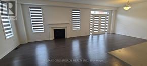 Pickering apartment for rent - A large, empty room with a fireplace and wooden floors.