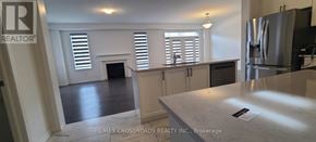 Pickering apartment for rent - A kitchen with a refrigerator and a counter top.