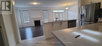 Pickering apartment for rent - A kitchen with a refrigerator and a counter top.