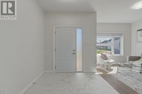 London South (South V) apartment for rent - A white interior room with a door, a couch, and a window.