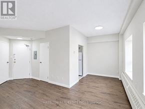 Toronto (Parkwoods-Donalda) condo for rent - A room with a white door, a white wall, and a white fridge.