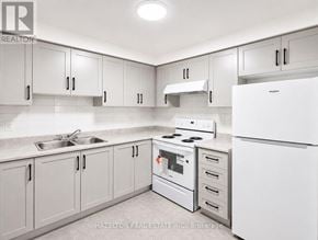 Toronto (Parkwoods-Donalda) condo for rent - A kitchen with white appliances and cabinets.