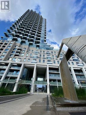 Toronto (Waterfront Communities) condo for rent - A tall building with a sculpture in front of it.