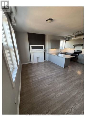 Hamilton (Gibson) townhouse for rent - A kitchen with a counter and a fridge.