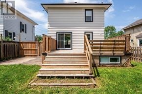 Niagara Falls (Downtown) apartment for rent - A house with a white exterior and a wooden deck.