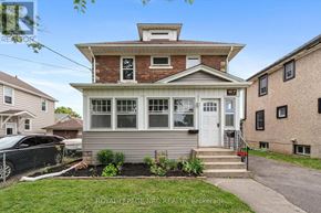 St. Catharines (Downtown) apartment for rent - A house with a white door and windows is for sale.