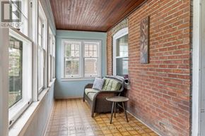 St. Catharines (Downtown) apartment for rent - A room with a brick wall and a couch.