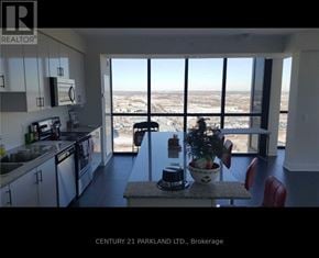 Vaughan (Concord) condo for rent - A kitchen with a view of the cityscape outside the window.