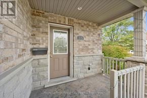 Guelph (Pineridge/Westminster Woods) townhouse for rent - A brown door is on the front of a house.