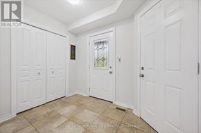 Guelph (Pineridge/Westminster Woods) townhouse for rent - A hallway with white doors and a tiled floor.