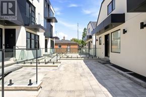 Toronto (Oakwood Village) townhouse for rent - A row of modern houses with balconies and a sign that reads REALTOR.