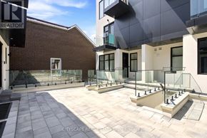 Toronto (Oakwood Village) townhouse for rent - A modern building with a glass balcony and a brick wall.