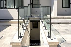Toronto (Oakwood Village) townhouse for rent - A glass staircase leads down to a small pool.