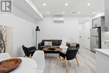 Toronto (Oakwood Village) townhouse for rent - A modern living room with a black sofa and wooden coffee table.
